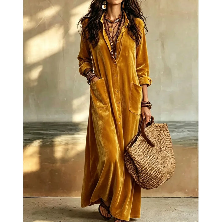 Woman wearing gold velvet button front maxi dress with patch pockets