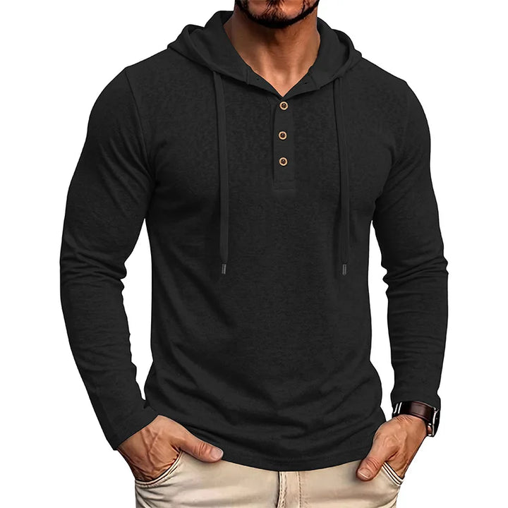 Man wearing black drawstring hooded pullover with half-button placket, front view