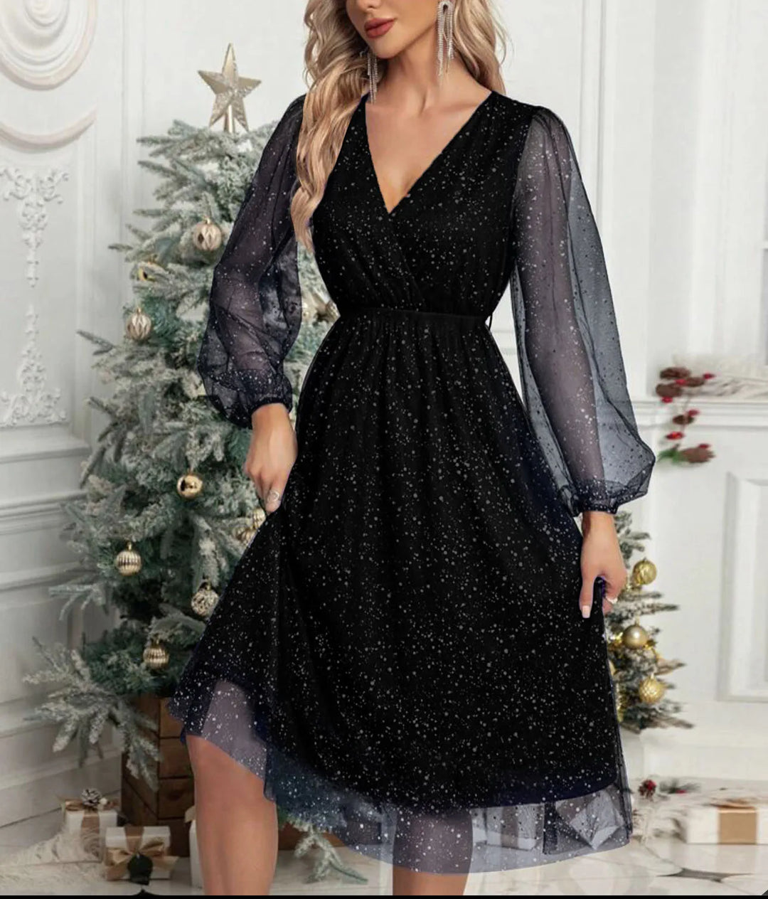 Woman wearing black glitter mesh wrap dress with balloon sleeves