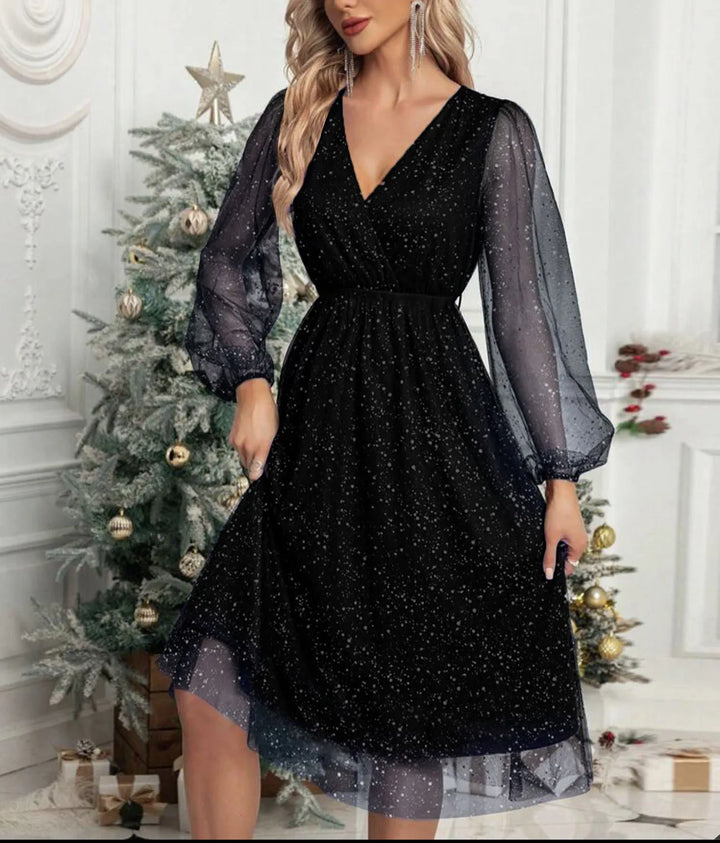Woman wearing black glitter mesh wrap dress with balloon sleeves