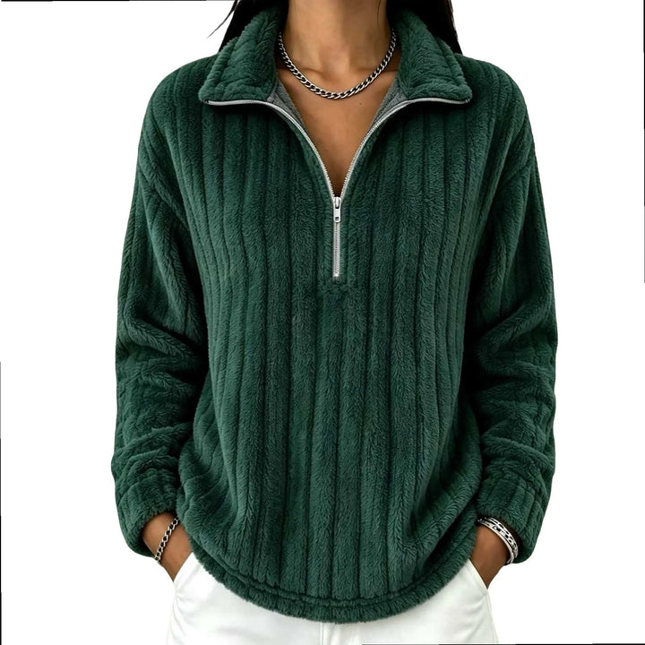 Woman wearing dark green ribbed quarter-zip pullover on white background