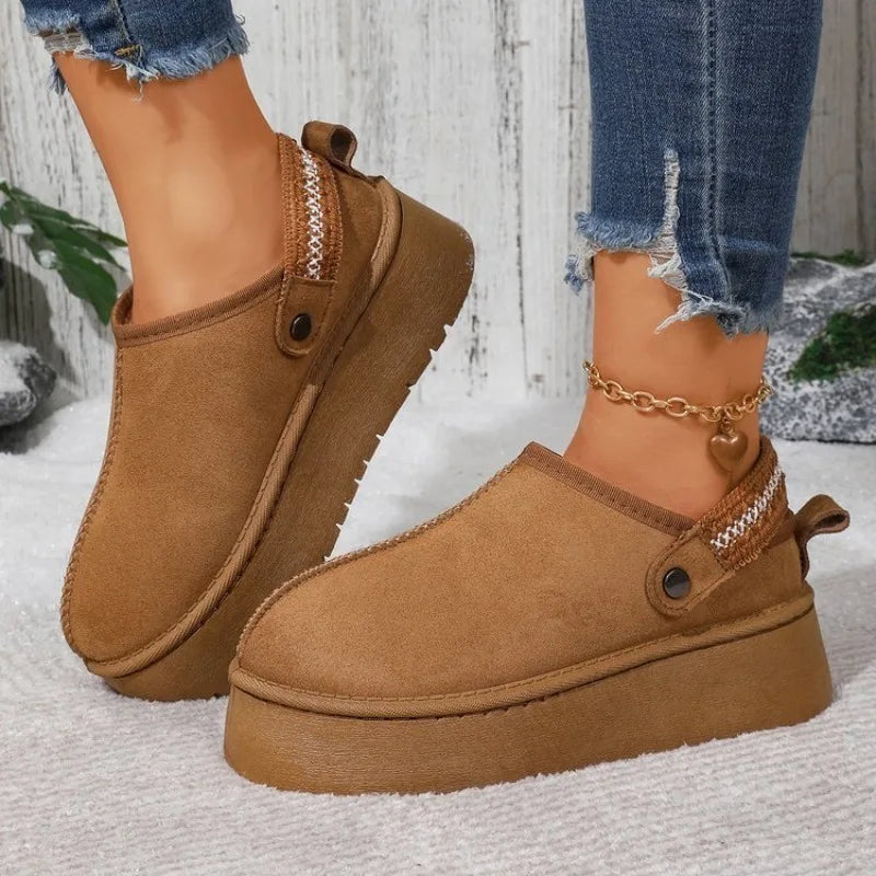 Model wearing camel faux suede platform clogs, side view