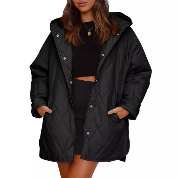 Woman wearing black diamond quilted hooded jacket with hands in pockets