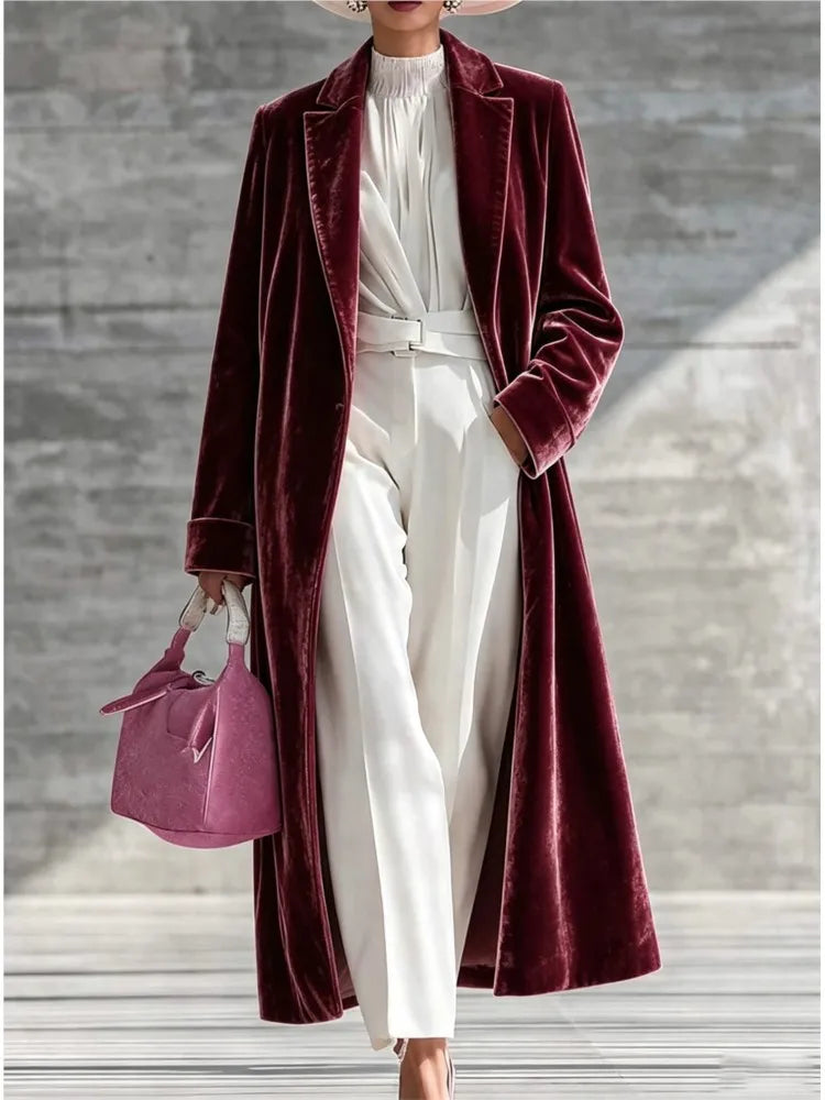 Woman wearing a burgundy velvet maxi coat with notched lapel