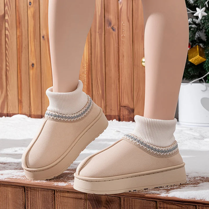 Khaki plush ankle boots worn outdoors in snow