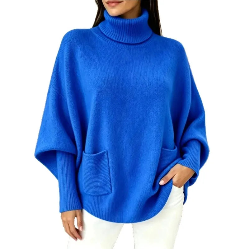 Woman wearing blue turtleneck batwing sweater with front pocket