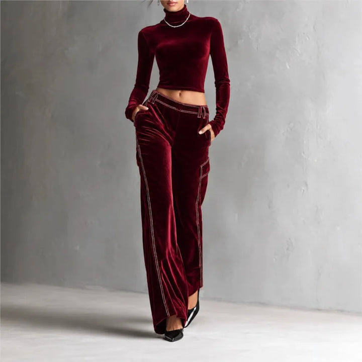 Woman wearing burgundy velvet cropped turtleneck and wide leg cargo pants set