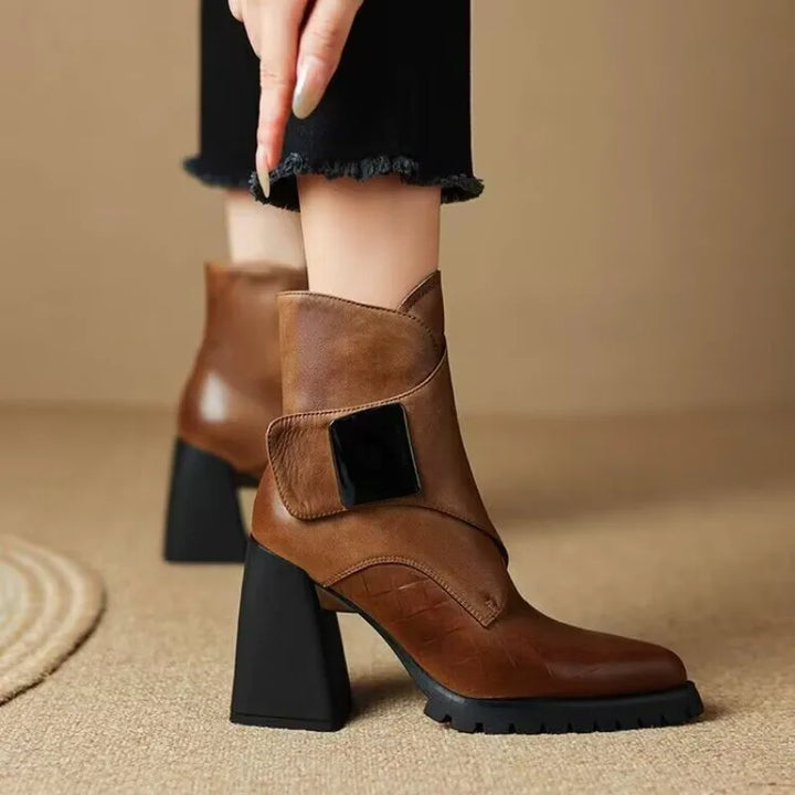 Brown ankle boot worn on model with hand detail
