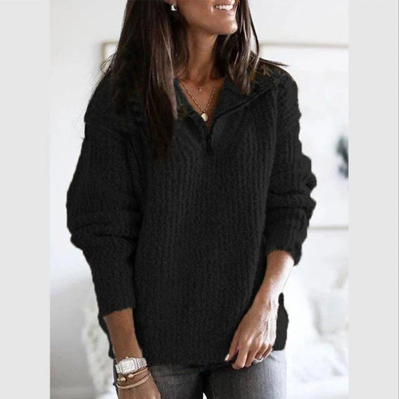 Woman wearing black textured knit quarter-zip sweater with stand collar
