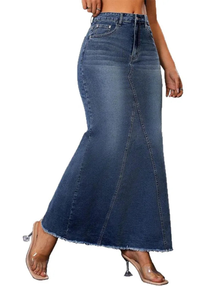 Side view of navy blue denim maxi skirt with raw frayed hem and heeled sandals