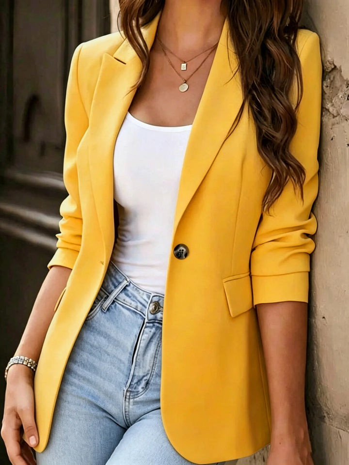 Yellow single button blazer close up on model