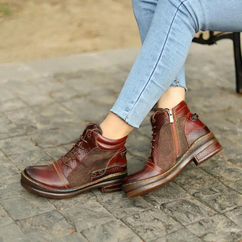 Woman seated wearing brown ankle boots showing side zip and lace detail