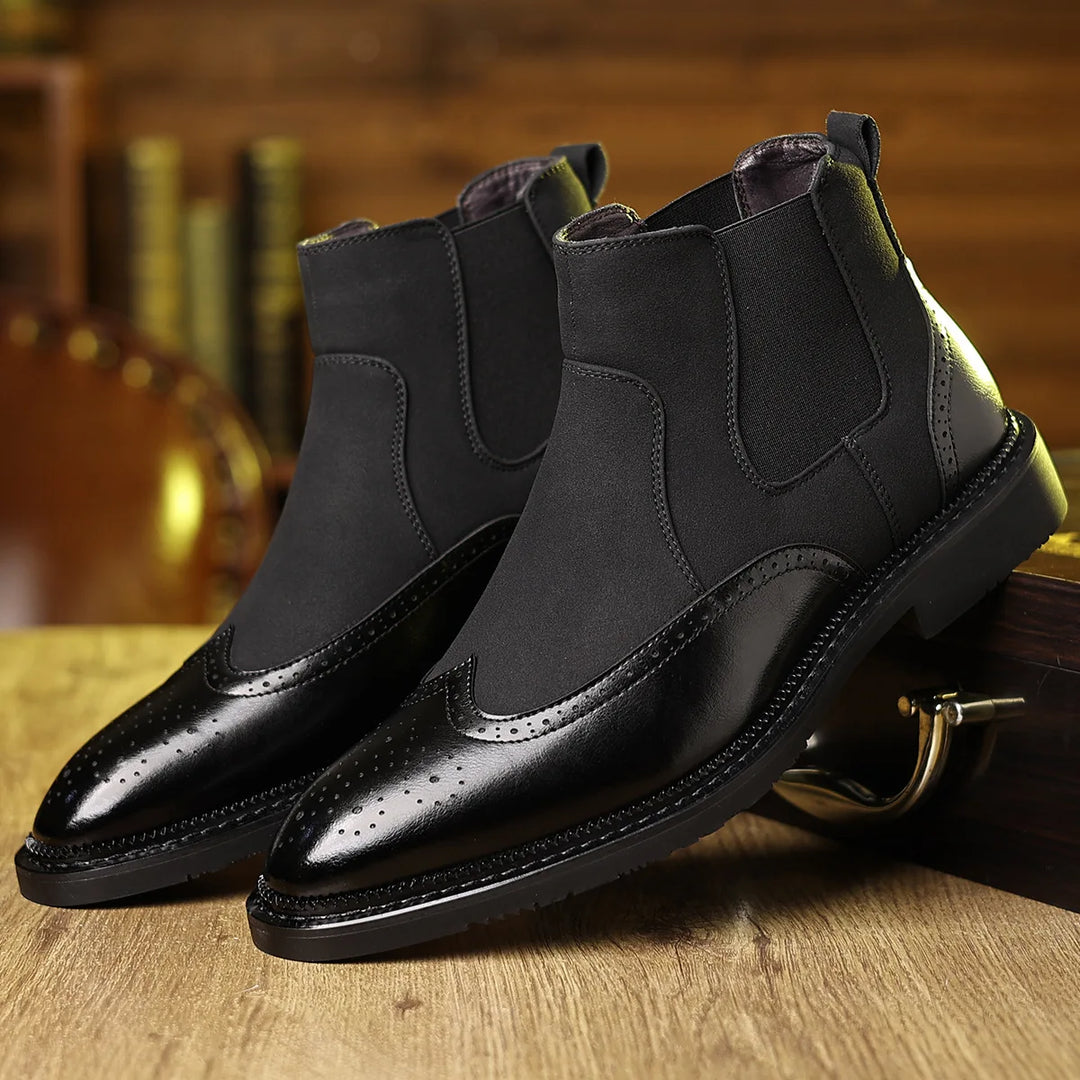 Pair of black Chelsea boots with brogue wingtip toe
