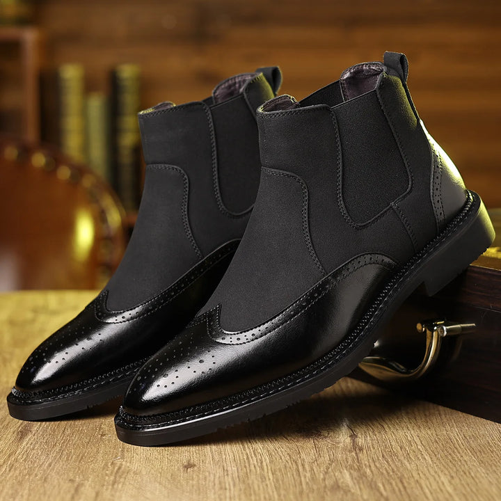 Pair of black Chelsea boots with brogue wingtip toe