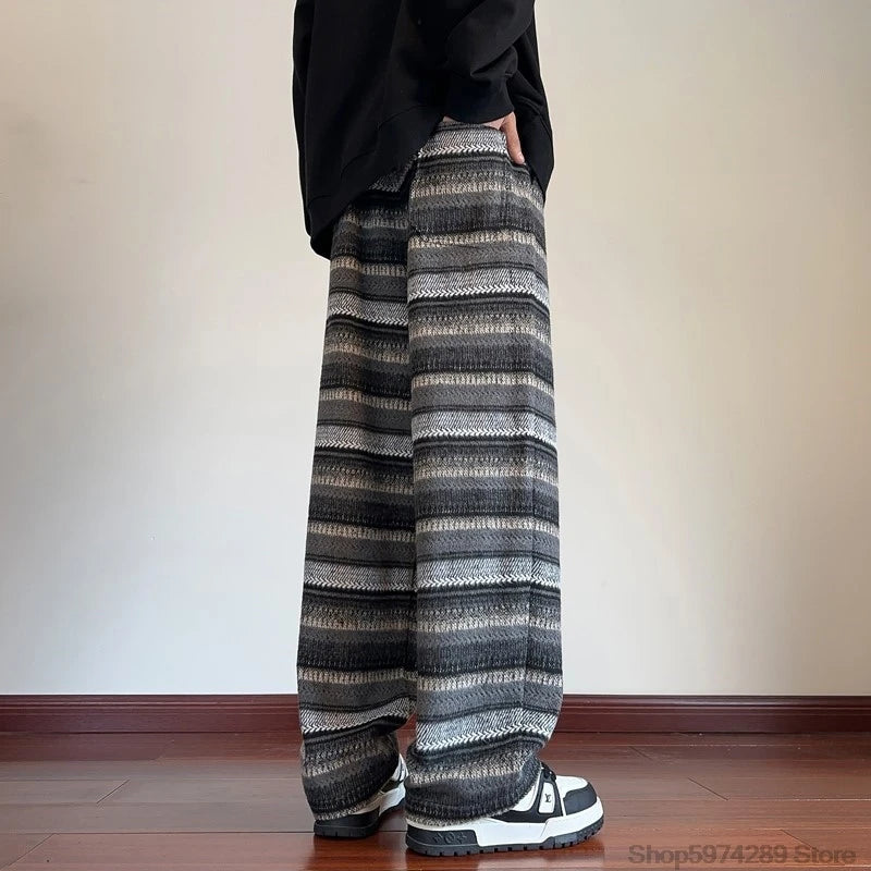 Back view of black striped wide leg pants with hand in pocket