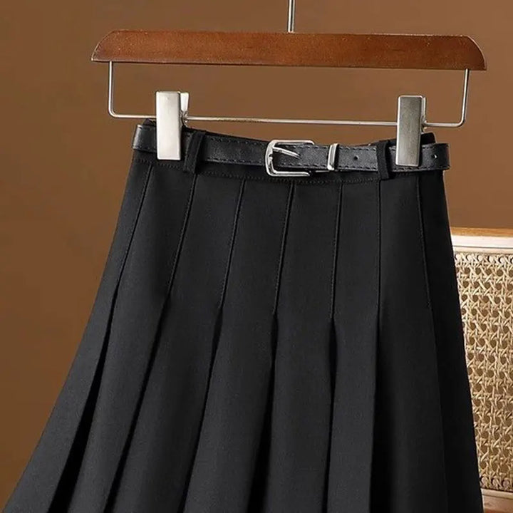 Close up of black pleated skirt waistband and belt
