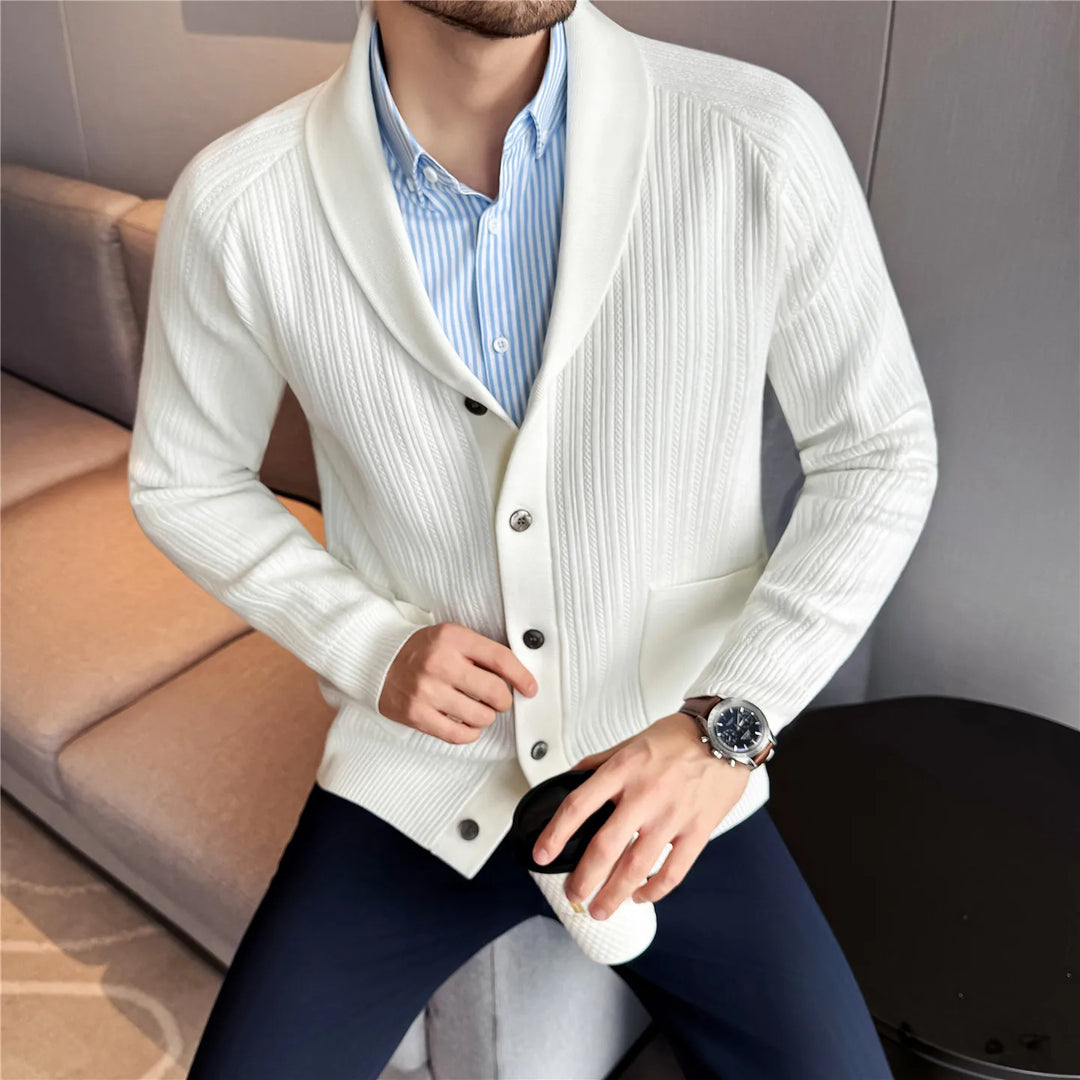 Man wearing white shawl collar ribbed knit cardigan over blue striped shirt