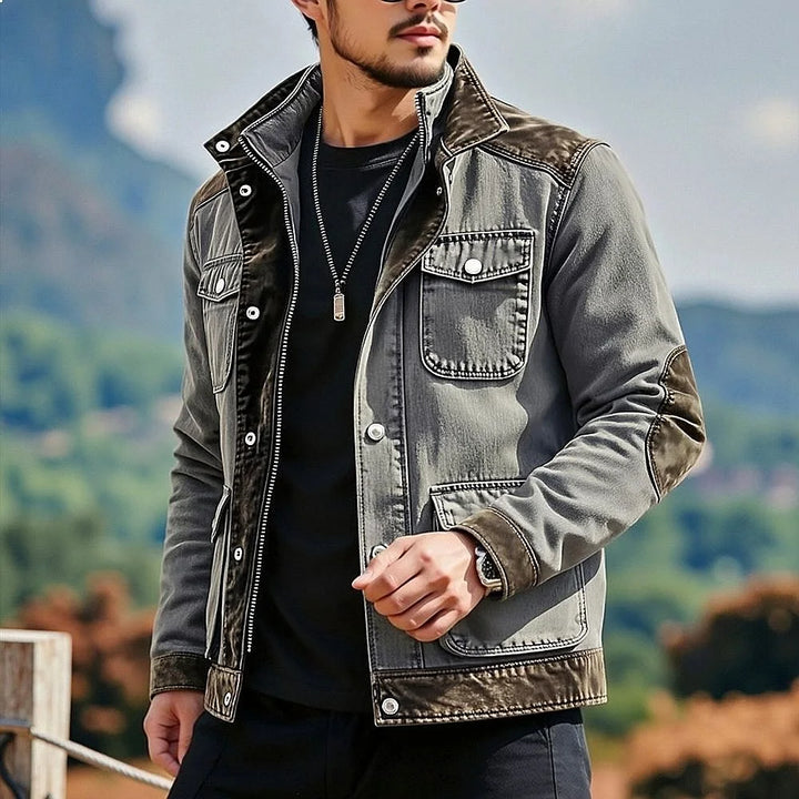 Man wearing gray contrast panel denim jacket, front view