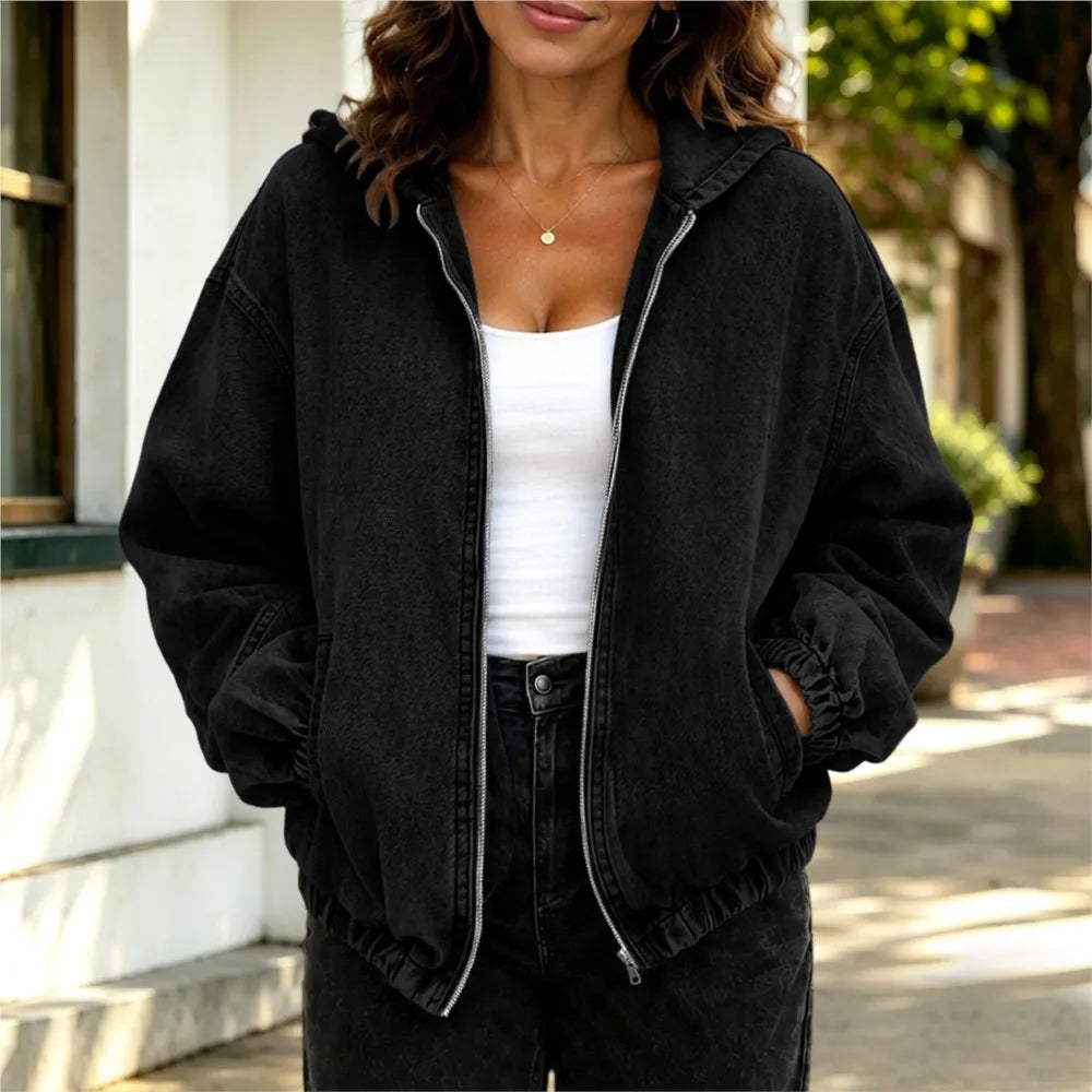 Woman wearing black oversized hooded denim jacket, front view