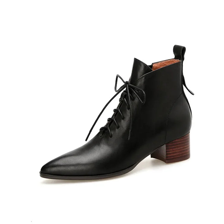 Black leather lace-up ankle boot on white background, angled view
