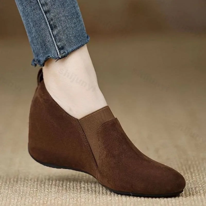 Brown suede wedge bootie side view worn with jeans