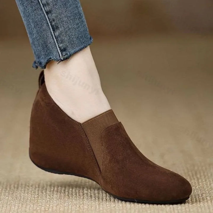 Brown suede wedge bootie side view worn with jeans