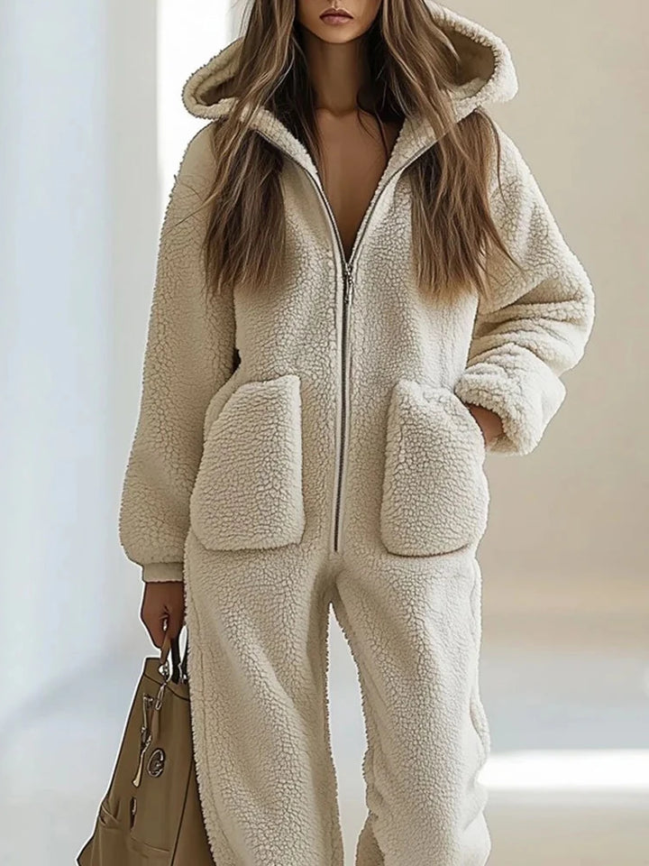 Close up of cream sherpa hooded jumpsuit with zip front and pockets