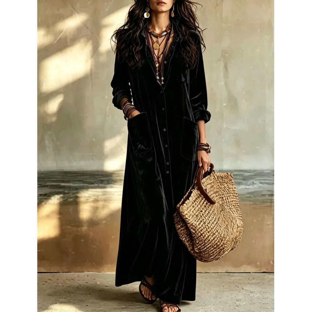 Woman wearing black velvet button front maxi dress with patch pockets