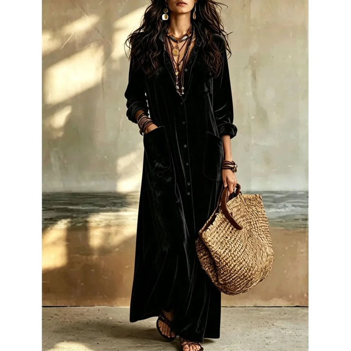 Woman wearing black velvet button front maxi dress with patch pockets