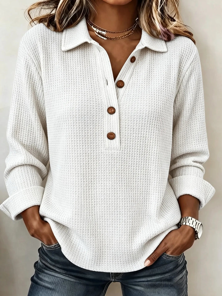 Woman wearing white waffle knit top with collar and button placket