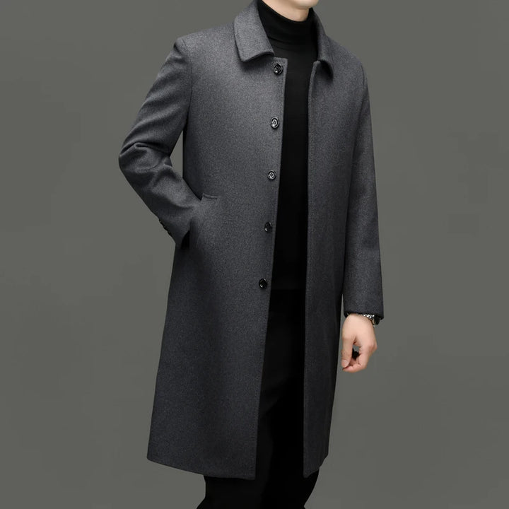 Man wearing grey mid-length wool coat, three-quarter view