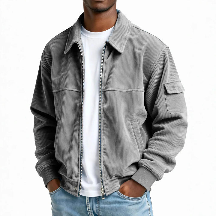 Man wearing grey corduroy zip jacket with flap pocket
