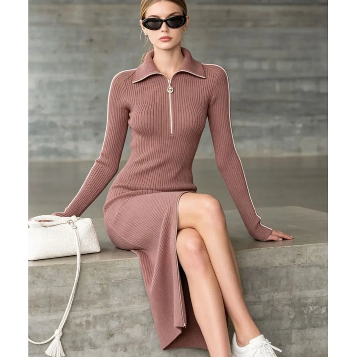 Model seated in mauve ribbed knit sweater dress showing side slit