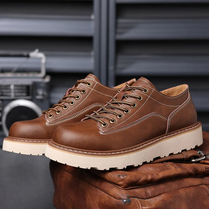 Pair of brown leather oxford shoes on bag