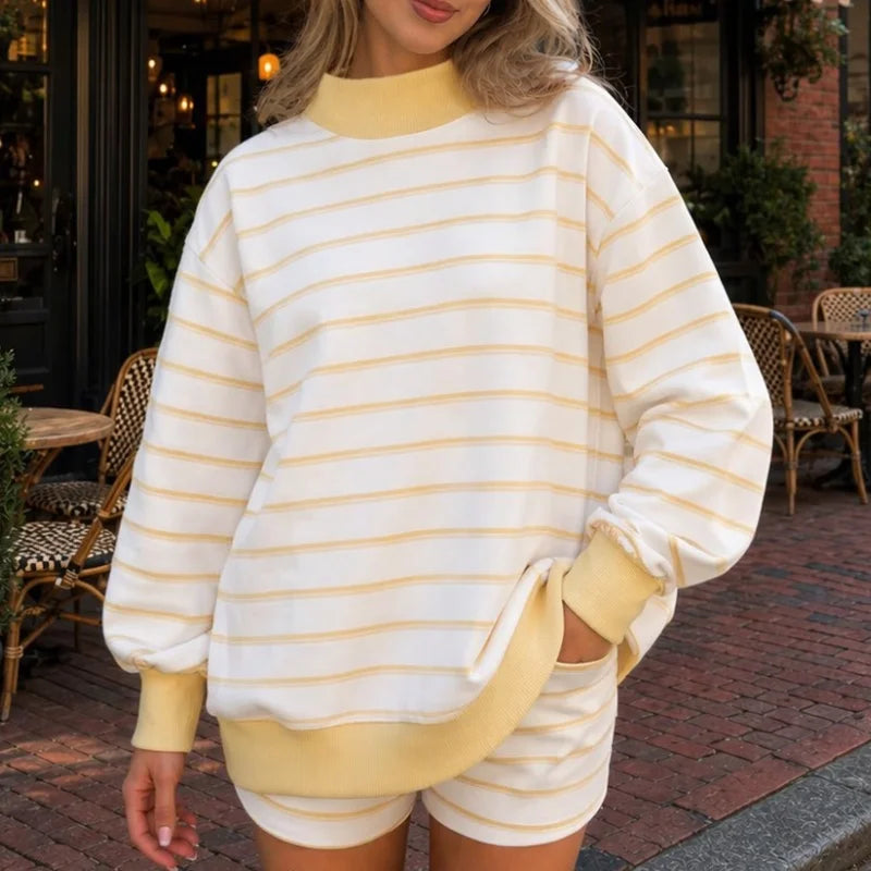 Woman wearing light yellow striped sweatshirt and shorts set