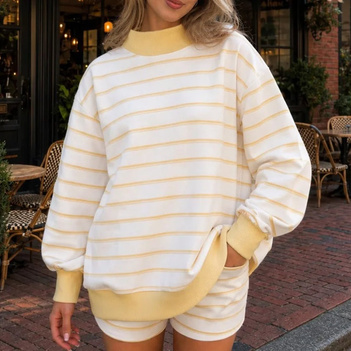 Woman wearing light yellow striped sweatshirt and shorts set