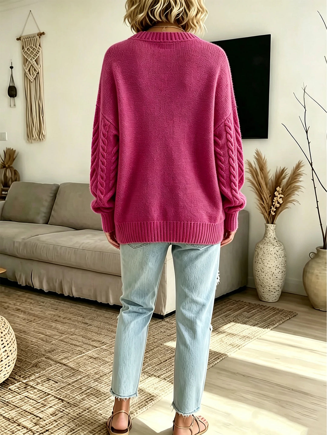 Back view of rose pink cable knit cardigan sweater