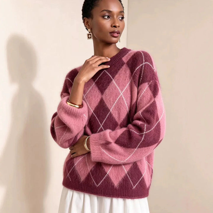 Woman wearing pink and burgundy argyle knit sweater