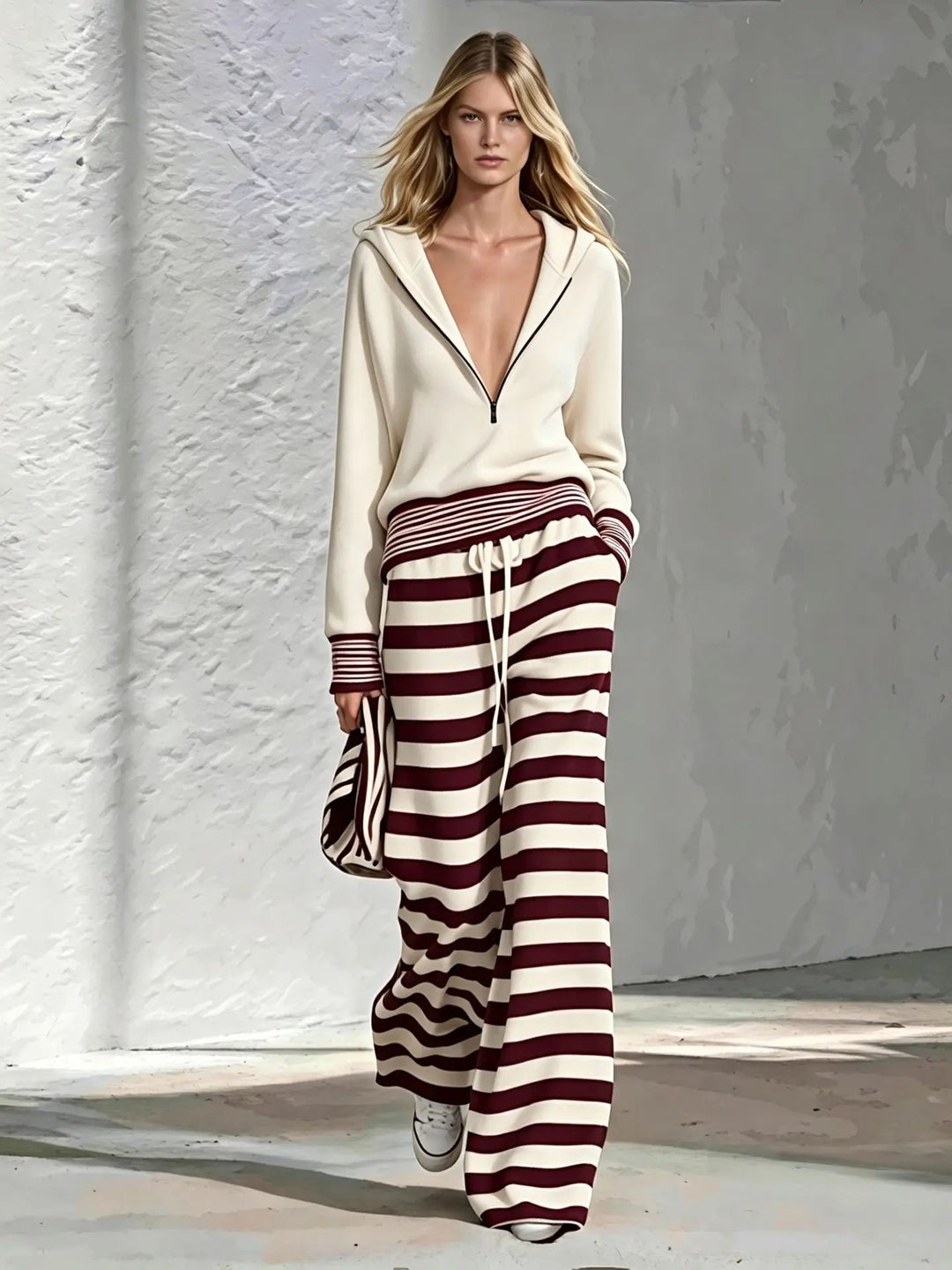 Cream half-zip hoodie with burgundy and white striped wide leg pants, front view