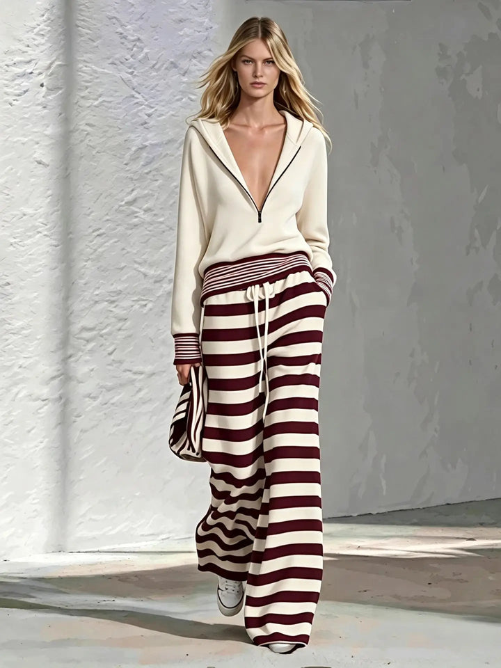 Cream half-zip hoodie with burgundy and white striped wide leg pants, front view