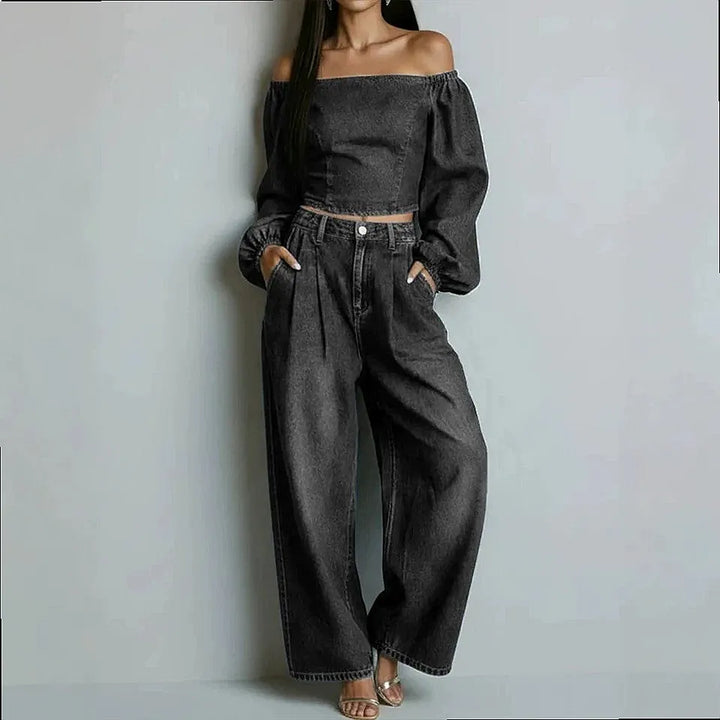 Woman wearing black denim off-shoulder crop top and wide leg pants set, front view