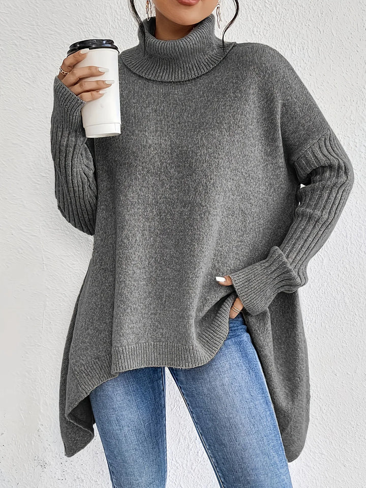 Woman wearing grey turtleneck sweater with ribbed cuffs