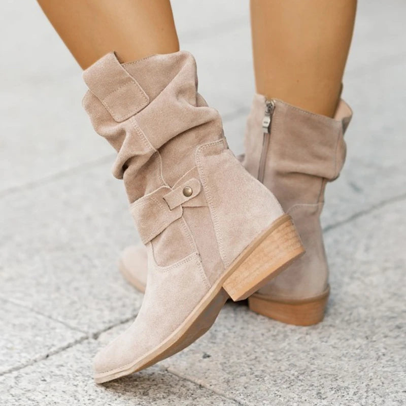Slouchy suede ankle boots in apricot with buckle strap detail, front view