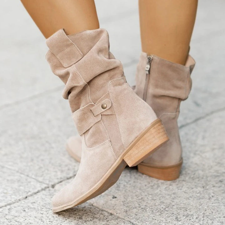 Slouchy suede ankle boots in apricot with buckle strap detail, front view