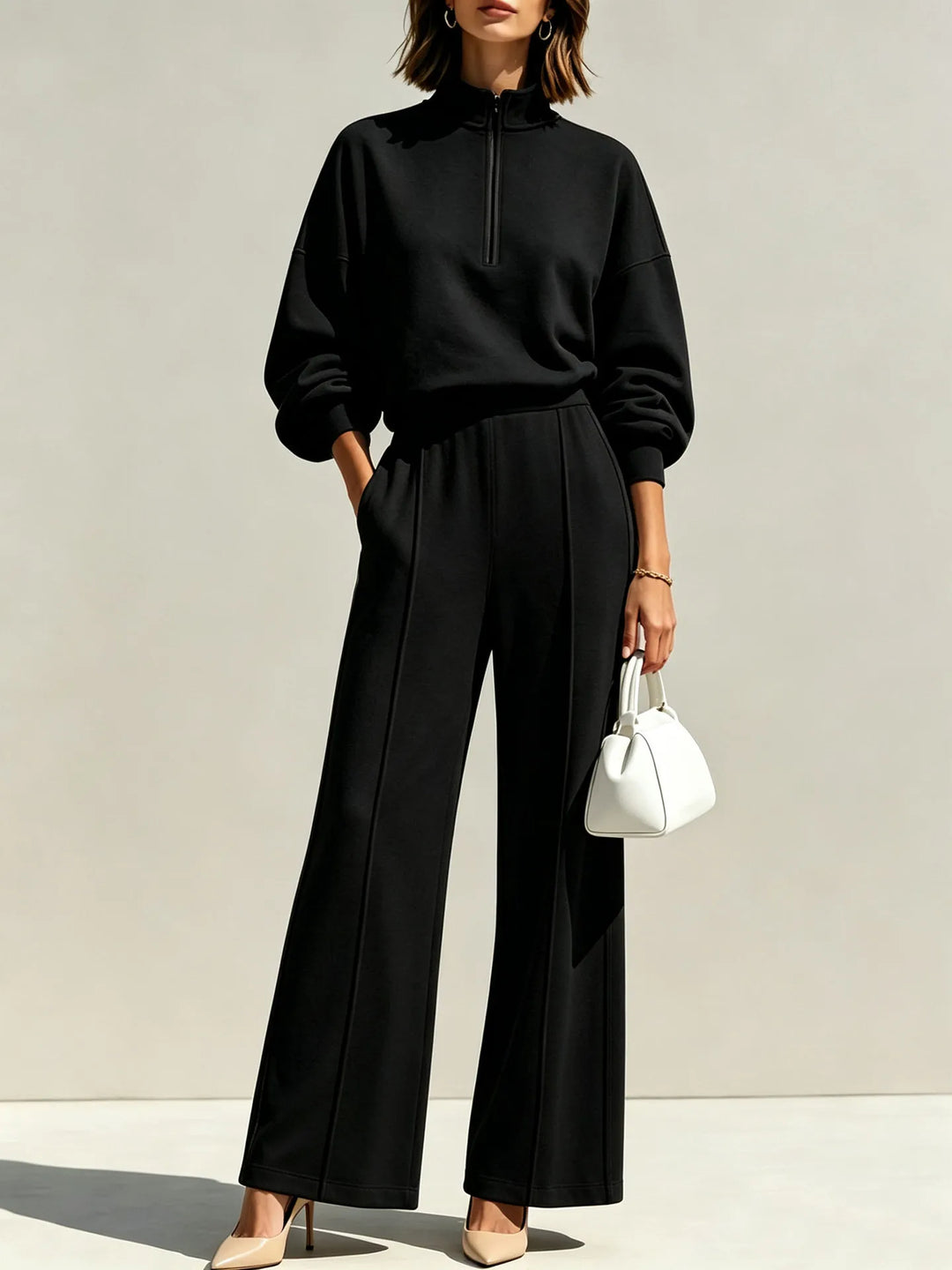 Woman wearing black half zip pullover and wide leg pants set