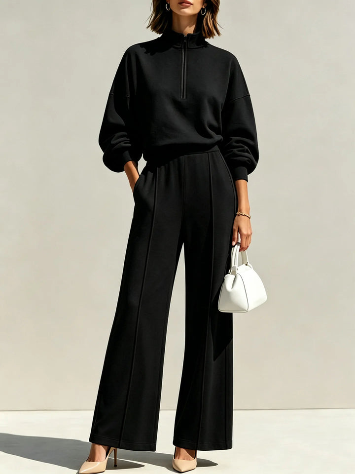 Woman wearing black half zip pullover and wide leg pants set