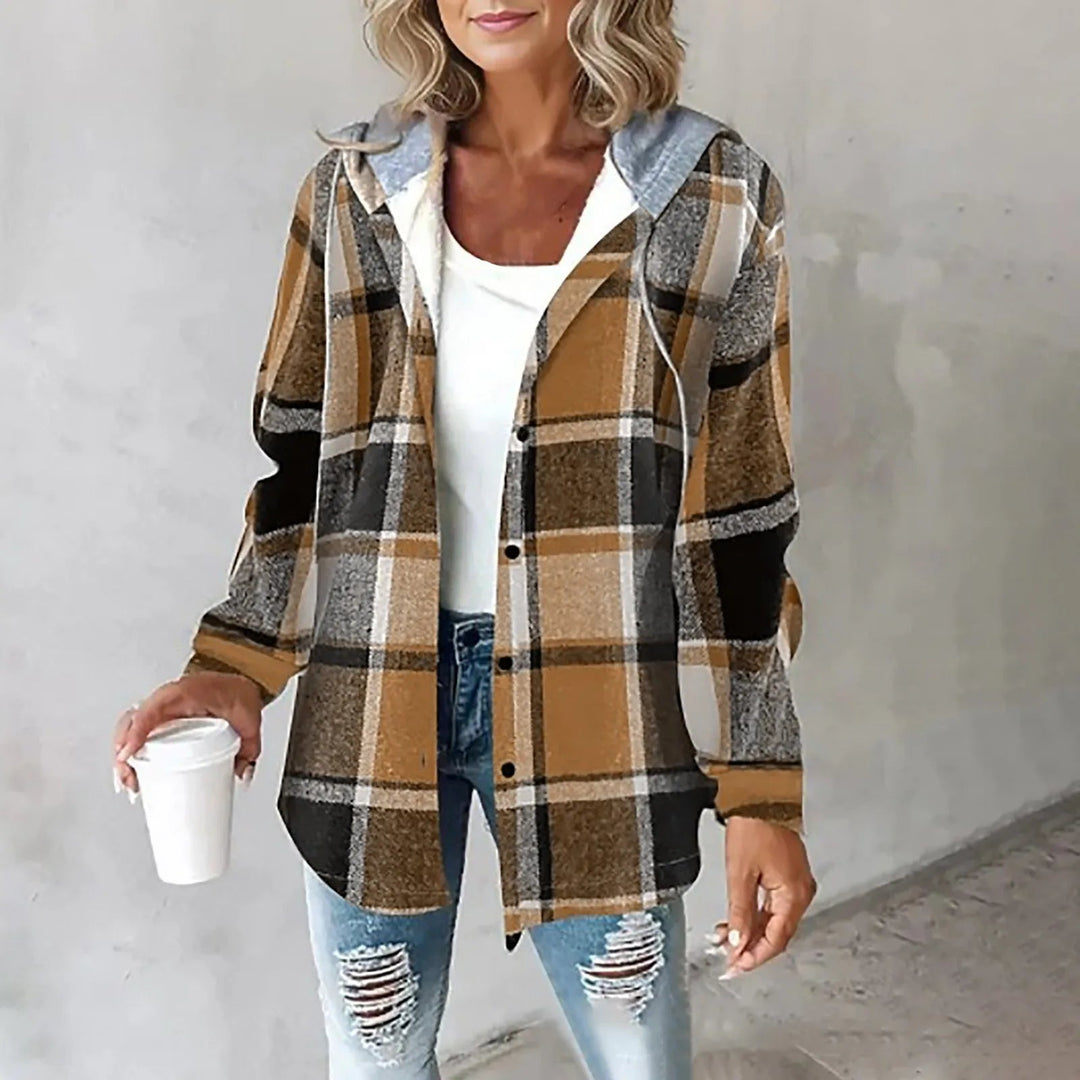 Woman wearing brown and tan plaid flannel shacket with hood