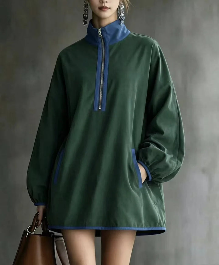 Green mini dress close up showing contrast zip and pockets