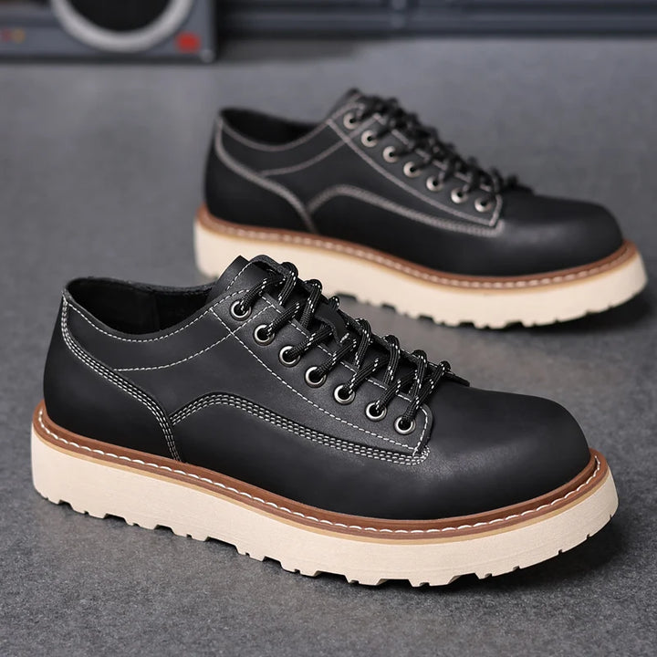 Pair of black leather oxford shoes side view