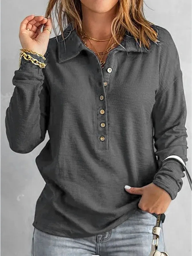 Woman wearing gray ribbed knit henley top with button front detail